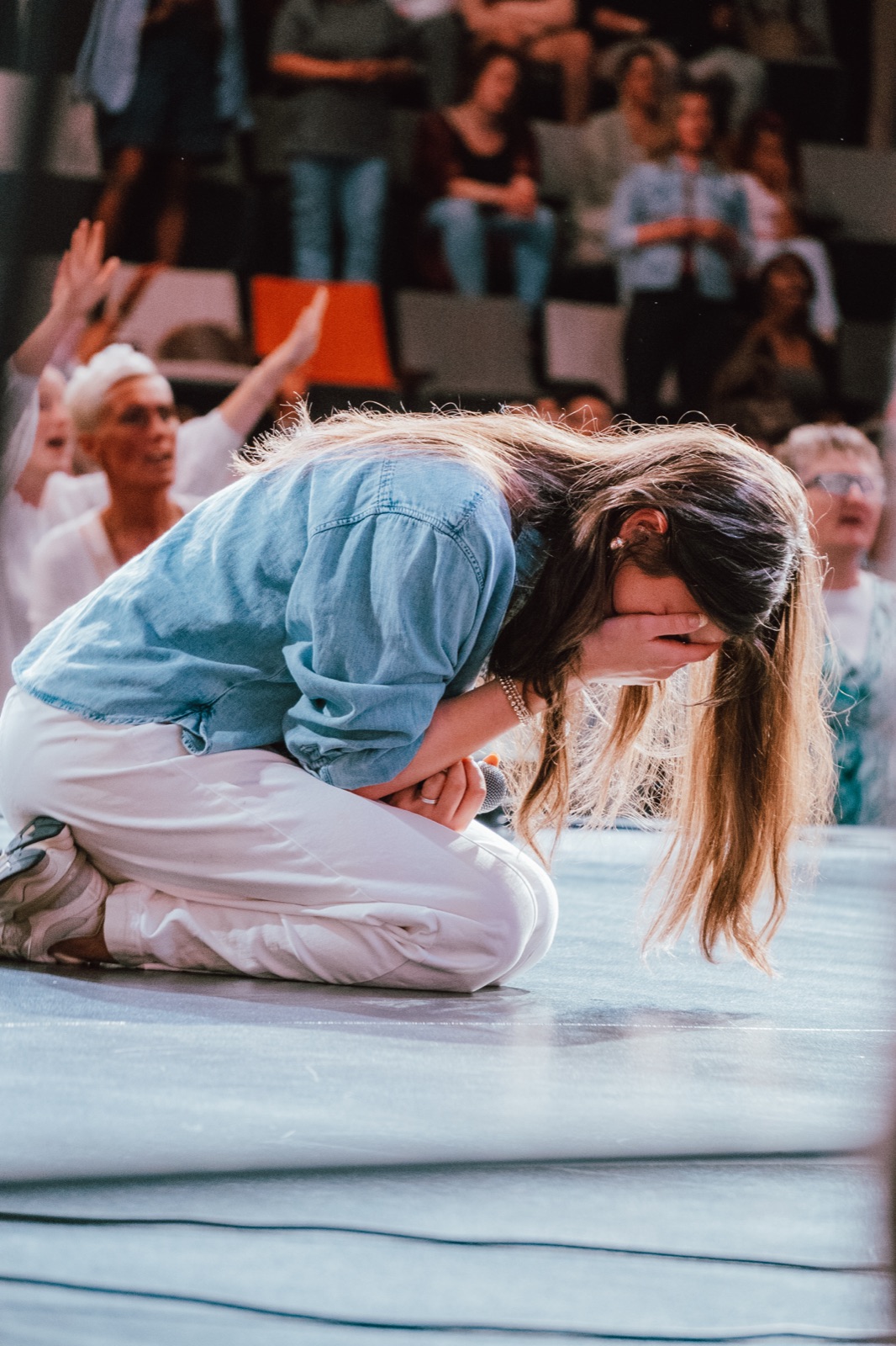 A woman kneeling in worship